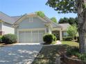 Charming home featuring a two-car garage and well-maintained landscaping at 4440 Cadmium Dr, Cumming, GA 30040