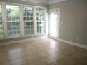 Sun-drenched sunroom with tile flooring and access to the backyard at 4440 Cadmium Dr, Cumming, GA 30040