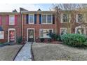 Beautiful brick townhome with classic design elements and well-maintained landscaping at 6118 Queen Anne Ct, Norcross, GA 30093
