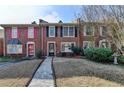 Attractive brick townhouse featuring colorful shutters and a well-cared-for lawn at 6118 Queen Anne Ct, Norcross, GA 30093