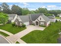 Aerial view of brick home with manicured lawn, driveway and a fenced in backyard at 380 Vista Creek Dr, Stockbridge, GA 30281