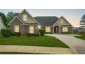 Beautiful single-story brick home with manicured lawn, charming curb appeal and driveway at 380 Vista Creek Dr, Stockbridge, GA 30281