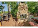 Outdoor stone fireplace featuring a Texas star for cozy lakeside evenings at 455 Mayo Rd, Covington, GA 30014