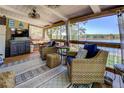 Inviting screened-in porch with comfortable seating, ceiling fans, and scenic lake views at 455 Mayo Rd, Covington, GA 30014