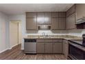This kitchen features stainless steel appliances, dark wood cabinets, and great countertop space at 5326 Rocky Pine Dr, Lithonia, GA 30038