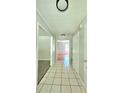 Tiled hallway leading to rooms, featuring neutral paint and simple lighting at 589 Catrina Ct, Stone Mountain, GA 30087