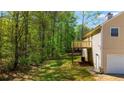 Lush backyard with a view of a wooded area from the upper deck at 379 Villa Rosa Way, Temple, GA 30179