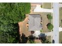 Aerial shot of a home featuring a gray roof, patio with an umbrella, and a long driveway at 4734 Eagles Ridge Loop, Lithonia, GA 30038