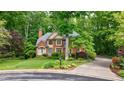 Beautiful brick home with mature trees and landscaping offering great curb appeal at 745 Devon Hill Ct, Roswell, GA 30075