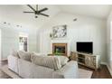 Inviting living room showcasing a fireplace, vaulted ceilings, hardwood floors, and comfortable furnishings at 45 Pine Tree Dr, Mcdonough, GA 30252