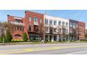 Stylish multi-story townhome complex featuring brick and painted exteriors with awnings and balconies at 89 E Andrews Nw Dr, Atlanta, GA 30305