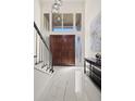 Bright foyer featuring tile floors, modern light fixture and staircase at 1178 Roxboro Ne Cv, Atlanta, GA 30324