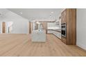 Open concept kitchen with large center island, stainless appliances, and wood and white cabinetry at 535 Shamrock Dr, Cumming, GA 30040