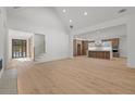 Open concept living room with vaulted ceilings, hardwood floors, and view of modern kitchen at 535 Shamrock Dr, Cumming, GA 30040