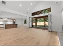 Open concept living room features soaring ceilings and folding doors to covered patio at 535 Shamrock Dr, Cumming, GA 30040