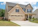 Traditional two-story home shows neutral siding, dark shutters, and a two-car garage at 537 Daffodil Ln, Mcdonough, GA 30253