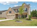 Two-story home features neutral siding, dark shutters and inviting front yard at 537 Daffodil Ln, Mcdonough, GA 30253