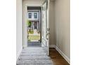 Inviting entryway with hardwood floors and a view of the charming home exterior through the open front door at 933 Catamaran Ct, Alpharetta, GA 30005