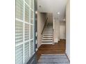 Welcoming entryway with hardwood floors, staircase with wooden banister, and a view into the home's layout at 933 Catamaran Ct, Alpharetta, GA 30005
