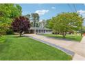 Landscaped front yard with a long driveway leading to a quaint single-story home at 1154 Pair Sw Rd, Marietta, GA 30060