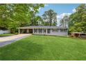 Charming single-story home with a well-manicured lawn and convenient carport at 1154 Pair Sw Rd, Marietta, GA 30060