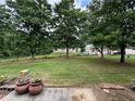 View of the spacious backyard with mature trees at 3871 Pleasant Oaks Dr, Lawrenceville, GA 30044