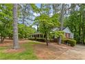 Inviting brick home with lush green landscaping, mature trees, and a classic, timeless architectural design at 681 Hampton Sw Pl, Marietta, GA 30064