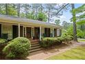 Inviting front porch with classic brick steps and a decorative front door, exuding charm and curb appeal at 681 Hampton Sw Pl, Marietta, GA 30064