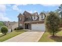 Attractive brick home with dormers, attached two-car garage and a well-kept lawn at 1612 Nations Trl, Riverdale, GA 30296