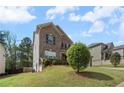 Charming two-story home with brick facade, blue shutters, and a lush green front yard at 1612 Nations Trl, Riverdale, GA 30296