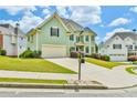 Charming two-story home with an attached garage and a beautifully landscaped front yard on a sunny day at 2727 Lost Mill Trce, Buford, GA 30519