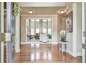 Elegant foyer with hardwood floors and an open view to the living room featuring large windows at 2727 Lost Mill Trce, Buford, GA 30519