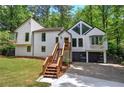 Modern white home featuring a unique architectural design, set against a backdrop of dense, mature trees at 3880 Northpoint Dr, Marietta, GA 30062