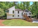 Unique two-story home with a walk-up entrance surrounded by lush greenery and a well-manicured lawn at 3880 Northpoint Dr, Marietta, GA 30062