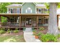 Inviting front porch with stone accents and a cozy swing at 5531 Hurstcliffe Nw Dr, Kennesaw, GA 30152