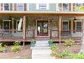 Charming front porch with stone accents and wooden railing details at 5531 Hurstcliffe Nw Dr, Kennesaw, GA 30152