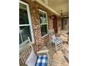 Relaxing front porch featuring rocking chairs on a stone floor, creating a welcoming outdoor space at 3397 Holly Glen Dr, Dacula, GA 30019