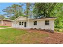 Charming one-story home with a well-maintained front yard and painted white brick at 1660 Mallard Cir, Conley, GA 30288