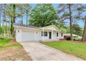 Charming one-story home with a well-maintained front yard and painted white brick at 1660 Mallard Cir, Conley, GA 30288