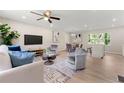 Bright living room with modern decor, featuring hardwood floors, stylish furniture, and a ceiling fan at 1660 Mallard Cir, Conley, GA 30288