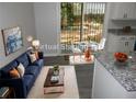 Open-concept living space with modern furniture, natural light, and a dining area at 257 E Simon Nw Ter, Atlanta, GA 30318