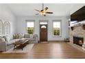Bright living room features hardwood floors, a cozy fireplace, and three light-filled windows at 275 Crowe Springs Nw Rd, Cartersville, GA 30121