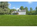 Traditional-style home with a stone facade and a well-maintained lawn at 3880 Dial Mill Ne Rd, Conyers, GA 30013