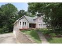 Attractive two-story house with a manicured lawn, complemented by a stone retaining wall and driveway at 5665 Stewart Woods Dr, Douglasville, GA 30135