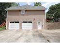 Spacious three-car garage featuring white doors and a convenient side entrance, providing ample parking at 5665 Stewart Woods Dr, Douglasville, GA 30135
