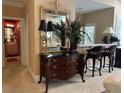 Hallway area features an antique dresser, ornate mirror, and a glimpse of the wet bar area at 999 Ashebrooke Ne Way, Marietta, GA 30068