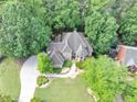 Expansive home with a long driveway, lush lawn, and meticulous landscaping at 1455 Lockridge Dr, Cumming, GA 30041