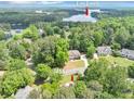 Breathtaking aerial view of the property near Lake Lanier surrounded by mature trees at 1455 Lockridge Dr, Cumming, GA 30041