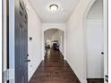 Elegant entryway featuring hardwood floors, arched doorways, and a view into a living area with a fireplace at 3425 Linstead Ct, Loganville, GA 30052