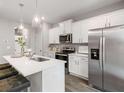 Modern kitchen featuring stainless steel appliances, sleek white cabinets, and a large kitchen island with stylish seating at 5623 Hislop Ln # 84, Mableton, GA 30126
